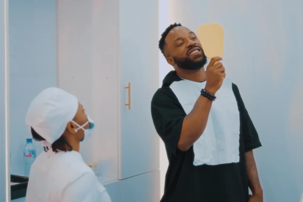 Nigerian man brushing teeth in mirror – dental hygiene Lagos Nigeria