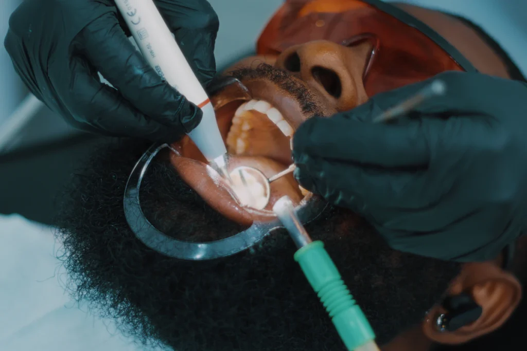 African Nigerian woman getting teeth checked by dentist in Lagos